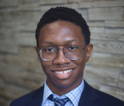 A professional headshot of Tremar Thomas